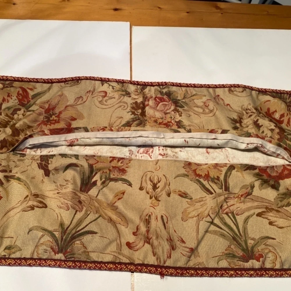 Red and brown pillow covers with zipper and cording. 35” wide 15” depth.